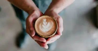 person holding coffee cup