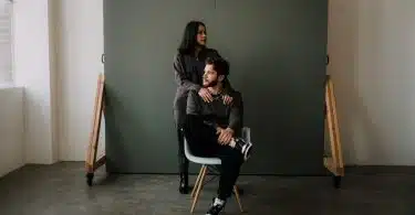 woman in black jacket sitting on white chair