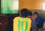 man wears yellow and green jersey shirt