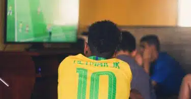 man wears yellow and green jersey shirt