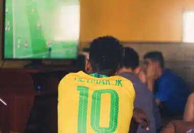 man wears yellow and green jersey shirt