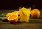 orange juice in clear drinking glass