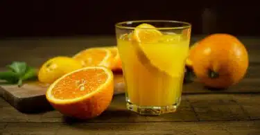 orange juice in clear drinking glass