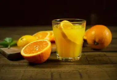 orange juice in clear drinking glass